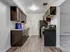 A modern kitchen with sleek dark wood cabinets, stainless steel appliances, and high-quality, durable flooring.