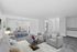 A welcoming living room at The Greenbriar Apartments, showcasing a comfortable couch, dining table, and a TV for leisure.