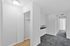 The Greenbriar Apartments' white hallway includes a closet on one side and a door at the far end, creating a spacious feel.