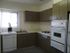 A cozy kitchen in The Greenbriar Apartments featuring a stove, refrigerator, sink, and microwave for all your cooking needs.