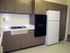 The Greenbriar Apartments kitchen showcasing a refrigerator, stove, and sink, perfect for culinary adventures.