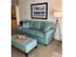 A furnished two-bedroom oak apartment at the Reserve at Sawmill, featuring a blue couch.