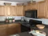 A two-bedroom apartment with a kitchen featuring wooden cabinets, decorative items, bowls, and more is available at the Reserve at Sawmill.