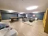 Spacious community lounge at Residences at Pleasant Ridge Apartments featuring a pool table, couches, and a television.