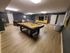 A billiard and pool table in the game room of the Residences at Pleasant Ridge Apartments, inviting for friendly matches.