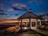 A gazebo at sunset, surrounded by a vibrant sky, located in the Highlands at Warwick.