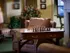 A chess board set up on a table with a chair beside it in the cozy lobby area of Highlands at Warwick.