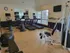 A well-equipped gym room with cardio machines and a television, part of the Highlands at Warwick fitness center.