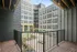 Balcony view overlooking the exterior of Lofts at Yard 56, showcasing the building's architecture and surrounding area.