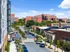 Street view of parked cars on both sides, with the Lofts at Yard 56 prominently visible in the background.