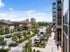 A bustling city street with cars parked on either side, showcasing the Lofts at Yard 56 nearby.