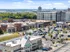 Aerial view of Lofts at Yard 56 shopping center, showcasing parking lots and surrounding retail spaces.
