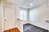 Inside Perkins Place Apartments, an empty room showcases a white door and a cozy carpeted floor.