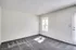 Unfurnished room in Perkins Place Apartments, showcasing a carpeted floor and bright white walls.
