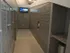 Long hallway at 500 Park Avenue Apartments featuring lockers on both sides and a television mounted on the wall.
