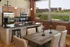 Bright kitchen at Lancaster Lofts with a table and chairs positioned before a textured brick wall.