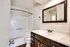 Bright bathroom at Perkins Place Apartments with a white sink and toilet, emphasizing a fresh and modern look.