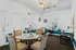 Bright and modern office space featuring a glass-top table, plush chairs, and ample natural light, ideal for productive work sessions at Greens at Schumaker Pond.