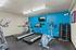 Fitness center in Greens at Schumaker Pond apartments, showcasing treadmills and a range of exercise machines.