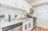 Stylish kitchen in Quiet Waters Landing, highlighting stainless steel appliances and pristine white cabinetry.