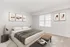 Inviting bedroom in Quiet Waters Landing, showcasing a bed, a nightstand, and artfully arranged pictures on the wall.