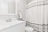 Quiet Waters Landing bathroom with a shower curtain and toilet, highlighting a tidy and inviting atmosphere.