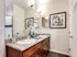 Elegant bathroom featuring a granite double vanity, chic artwork, and modern fixtures for a luxurious touch at Union Flats.