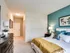 Elegant bedroom with a plush bed, stylish furnishings, and vibrant accent wall, offering a cozy and inviting atmosphere at Union Flats. .
