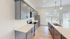 Sleek modern kitchen with elegant grey cabinetry, stainless steel appliances, and stylish pendant lighting over a spacious island at Emerson Flats.
