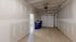 Spacious single-car garage with ample room for storage, featuring modern drywall finish and convenient overhead door opener at Emerson Flats..