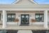Inviting modern entrance with large windows and elegant planter accents at Emerson Flats.