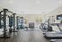 Modern fitness center with state-of-the-art equipment, including treadmills, weight machines, and free weights, offering a bright and energizing workout environment at Emerson Flats.