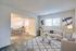 Bright living room in Meadow Creek Apartments showcasing a white couch, a dining table, and a television for entertainment.