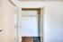 Inside Meadow Creek Apartments, a white closet with a door is set against a wooden floor.