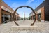 Charming outdoor plaza with modern brick architecture and cozy seating near popular cafes, perfect for leisurely strolls and relaxation near Yard 56 Loft.