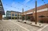 Vibrant outdoor plaza with modern brick architecture, trendy seating, and string lights for ambiance near Yard 56 Lofts.