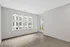 Bright and modern apartment with elegant hardwood floors, large windows offering natural light, and a cozy balcony at Yard 56 Lofts.