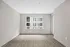 Bright and spacious room with modern flooring and large window offering an abundance of natural light at Yard 56 Lofts.