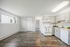 Bright and inviting open-concept kitchen with modern appliances and sleek wood flooring, perfect for comfortable living.