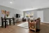 Inviting living room with elegant decor, featuring cozy seating, a stylish dining area, and abundant natural light.