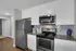 Modern kitchen with sleek stainless steel appliances, elegant granite countertops, and chic white cabinetry.