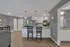 Modern open-concept kitchen with sleek white cabinets, elegant pendant lighting, and a stylish breakfast bar.