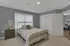 Inviting bedroom with stylish metal bed frame, elegant side table, and soft natural lighting, perfect for relaxation and comfort.