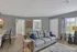 Inviting living room with plush sofa, elegant decor, and natural light streaming through large windows, perfect for relaxation.