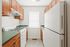 Charming kitchen featuring warm wooden cabinets and modern appliances, ideal for culinary creativity.