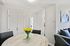 Elegant apartment interior with a sleek marble dining table, fresh yellow tulips, and modern artwork, creating a welcoming ambiance.