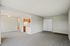 Bright and inviting open-plan living space with modern kitchen and cozy carpeted flooring.