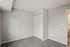 Bright and inviting bedroom with soft carpeting, ample closet space, and minimalist design.