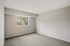 Bright and inviting bedroom with plush carpet and a large window offering scenic views.