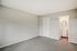 Bright and spacious room with plush carpeting, featuring a modern en-suite bathroom for ultimate comfort.
